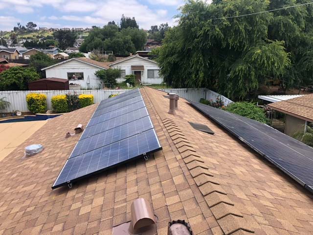  Solar panels installed on a residential roof in the San Diego area showcase renewable energy use.  