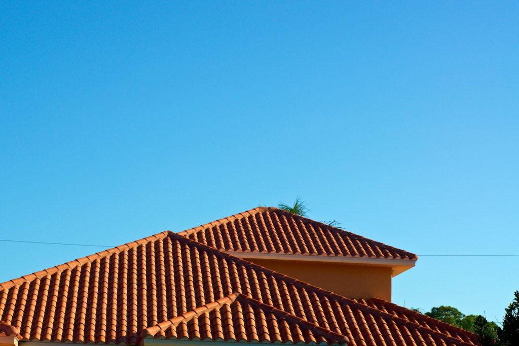 orange terra cotta rooftop against blue sky