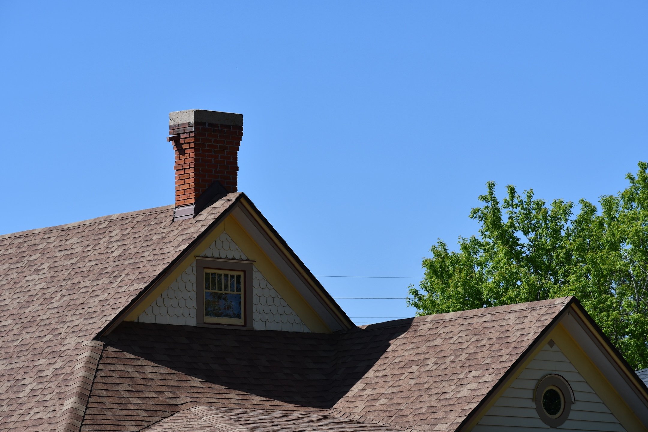 Historical home roofline. Beautiful brick chimney.