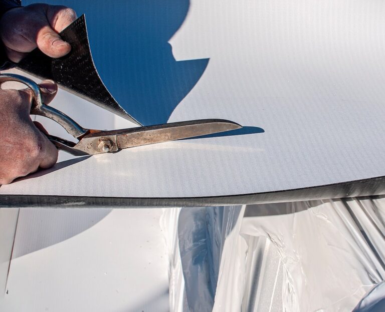 someone cutting roofing material