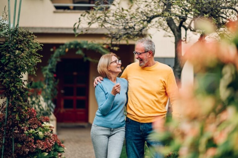 happy-older-couple-outside-of-house