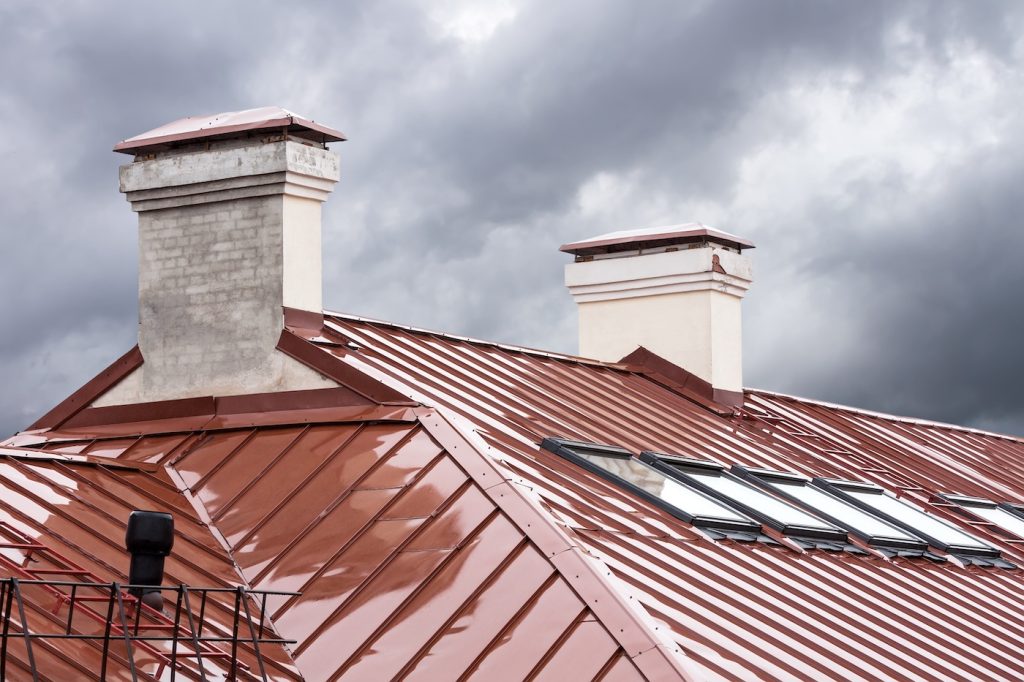 new red metal roof with skylights and chimneys