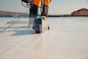 construction worker installing a TPO roof