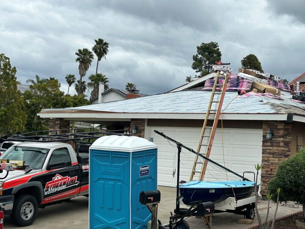 commercial roofers worker repairing roof house branded truck parked