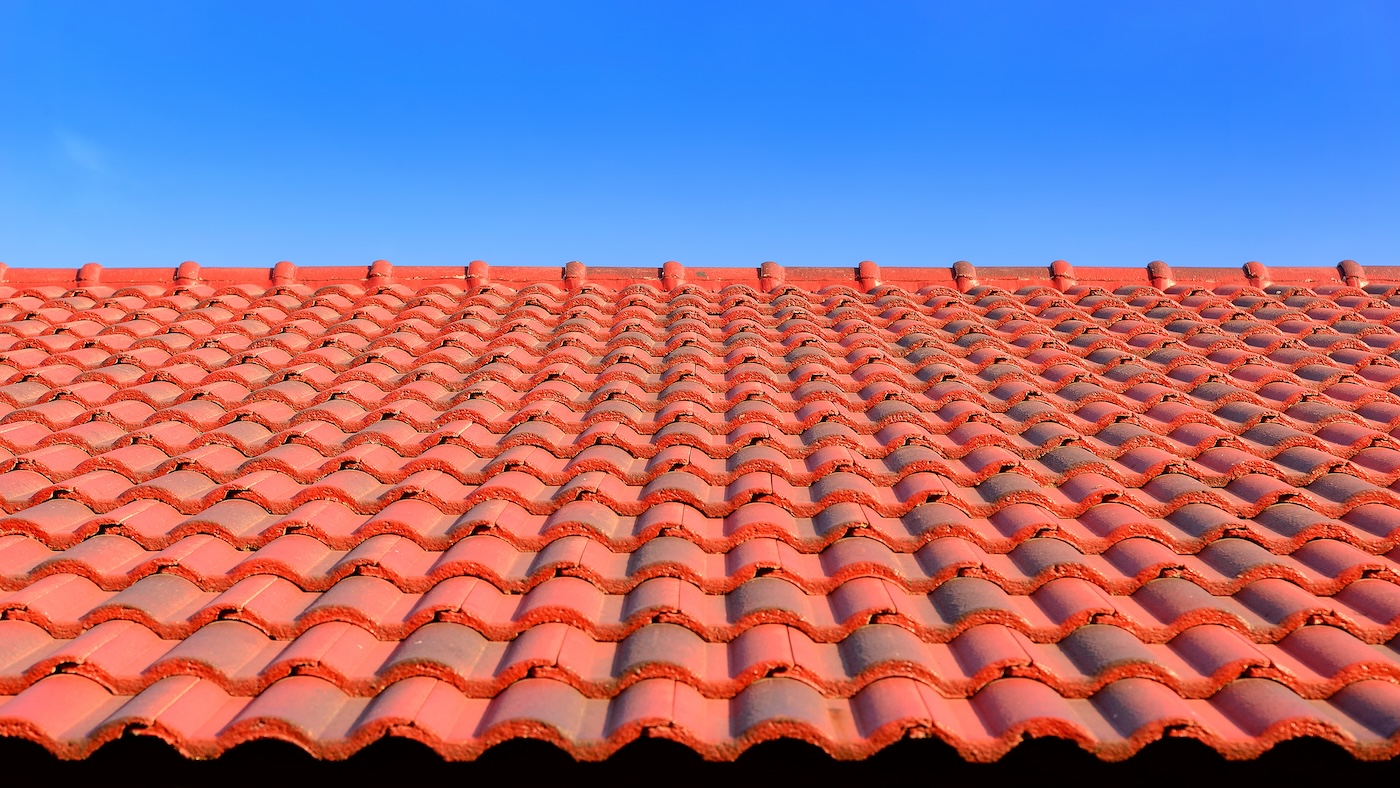 the red ceramic roof tile with sun light and blue sky,red ceramic roof tils and sunlight with the wide screen frame