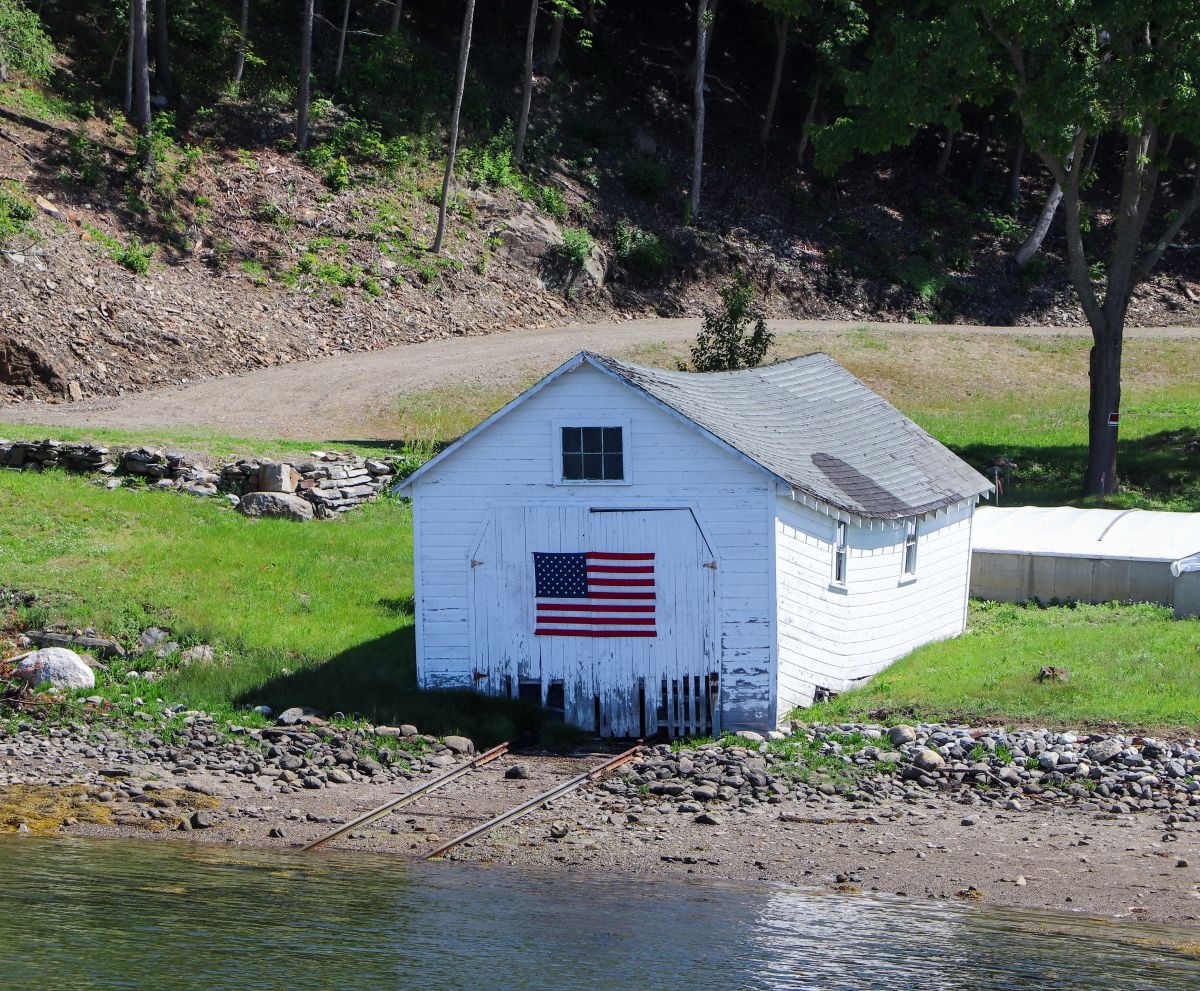 sagging roof small house next to lake